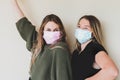 TwoÃÂ young women wearing face masks
